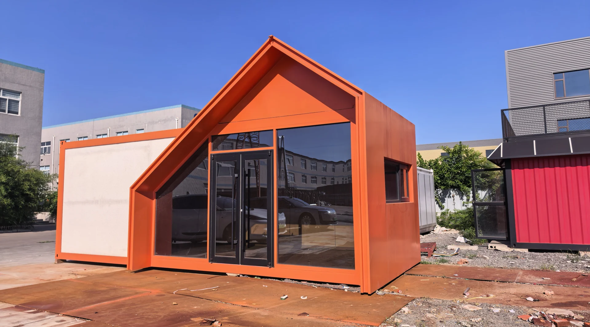 Orange modular building sample with glazed frontage and pitched facade detail