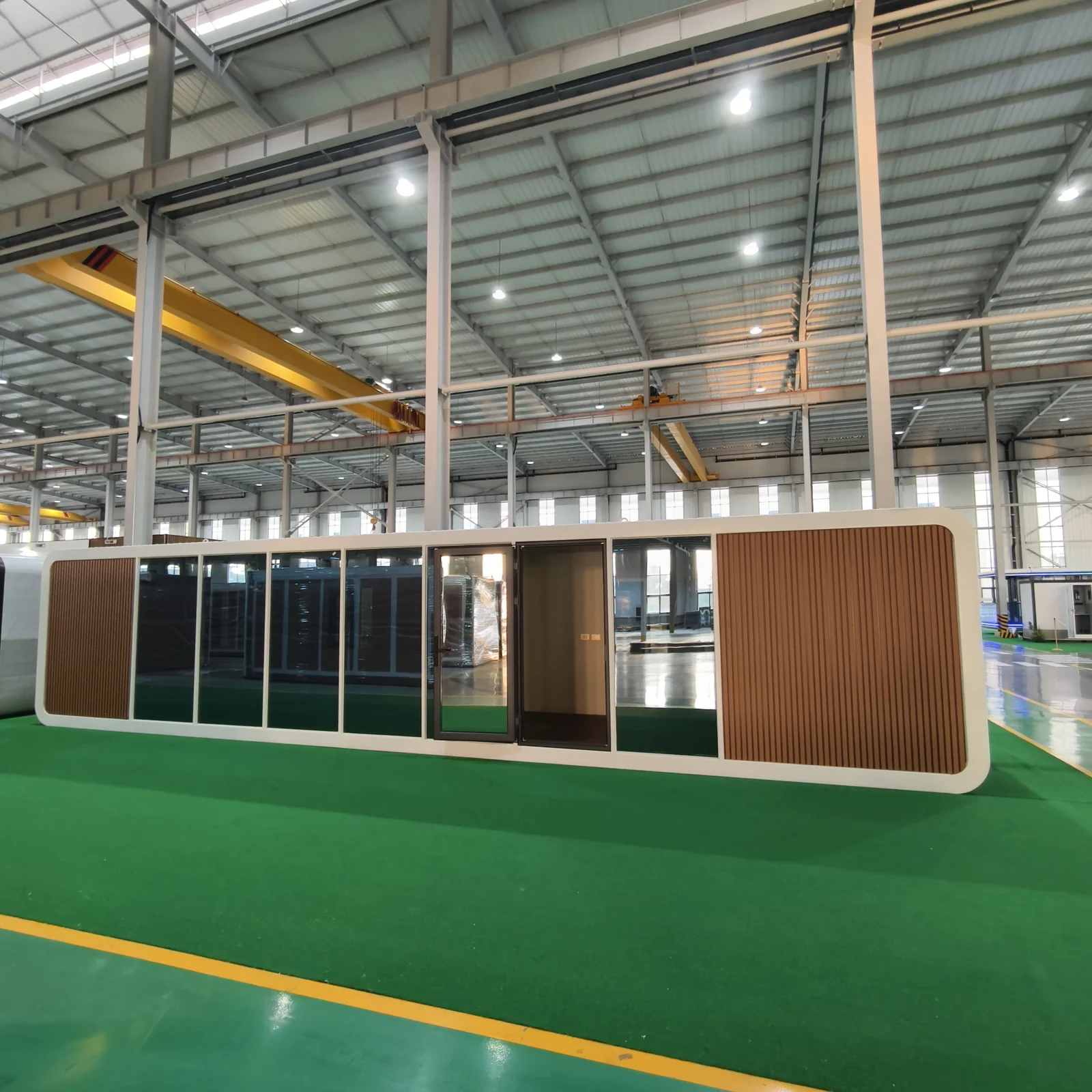Orange modular building sample with a glazed frontage at the factory
